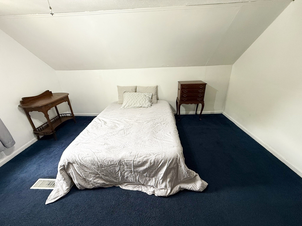 27 Cranmore Road Boston, MA 02136 - Photo 19 of 29 a bedroom with a bed and a chair