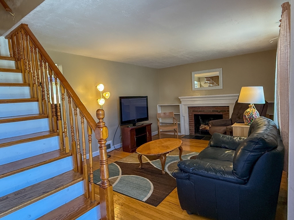 27 Cranmore Road Boston, MA 02136 - Photo 6 of 29 a living room with furniture fireplace and a flat screen tv