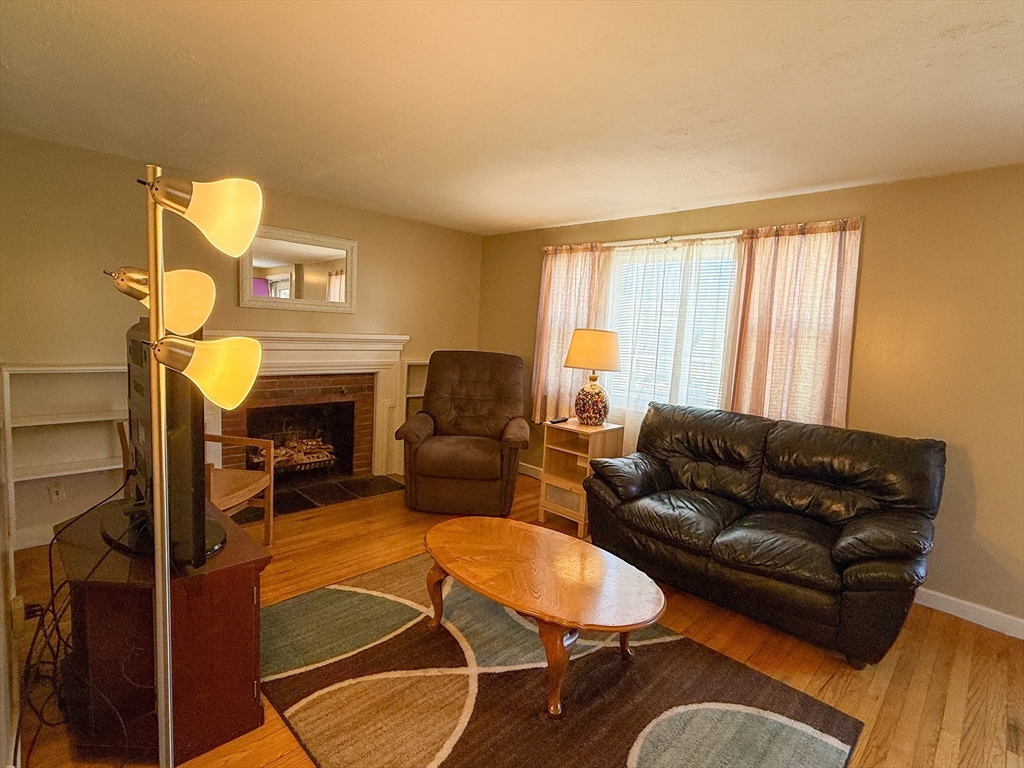 27 Cranmore Road Boston, MA 02136 - Photo 7 of 29 a living room with furniture and a fireplace