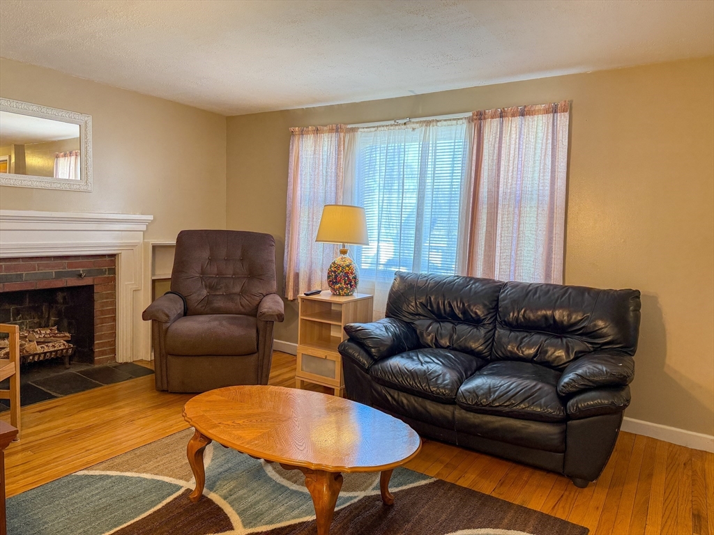 27 Cranmore Road Boston, MA 02136 - Photo 9 of 29 a living room with furniture and a fireplace