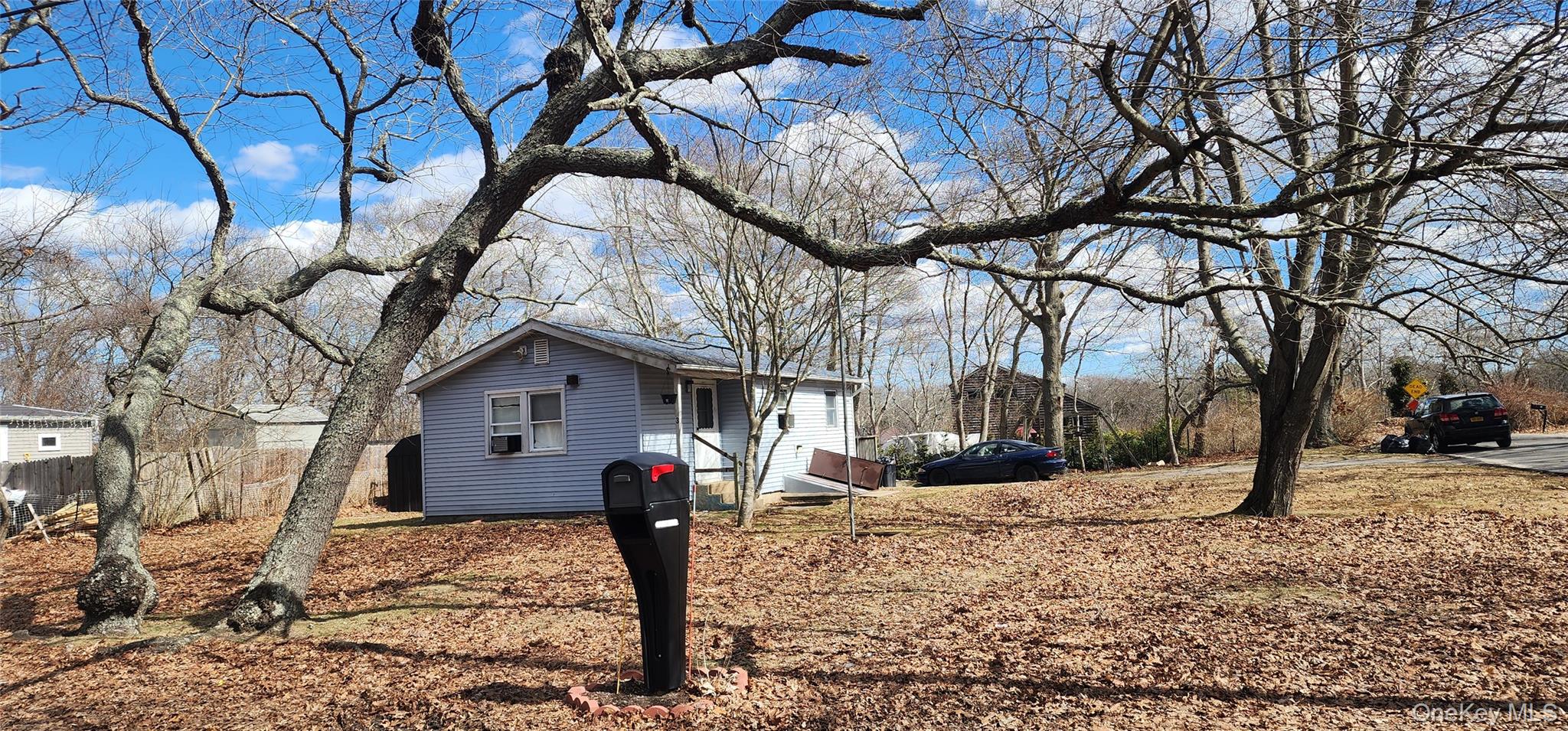 3 Rutland Road Mastic, NY 11950 - Photo 2 of 2 a front view of a house with a yard covered in snow