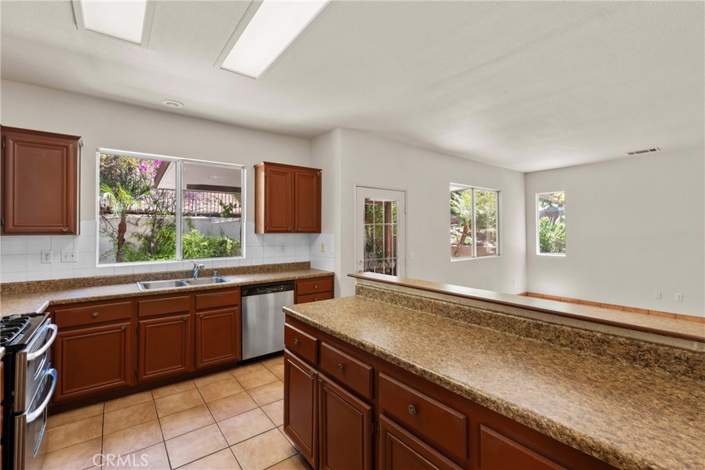 16200 Setting Sun Circle Riverside, CA 92503 - Photo 12 of 41 a kitchen with granite countertop stainless steel appliances sink and window