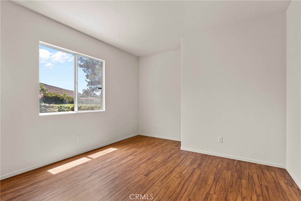 16200 Setting Sun Circle Riverside, CA 92503 - Photo 15 of 41 an empty room with wooden floor and windows