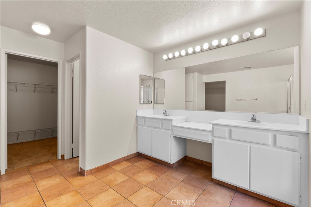 16200 Setting Sun Circle Riverside, CA 92503 - Photo 19 of 41 a bathroom with a double vanity sink mirror and cabinets