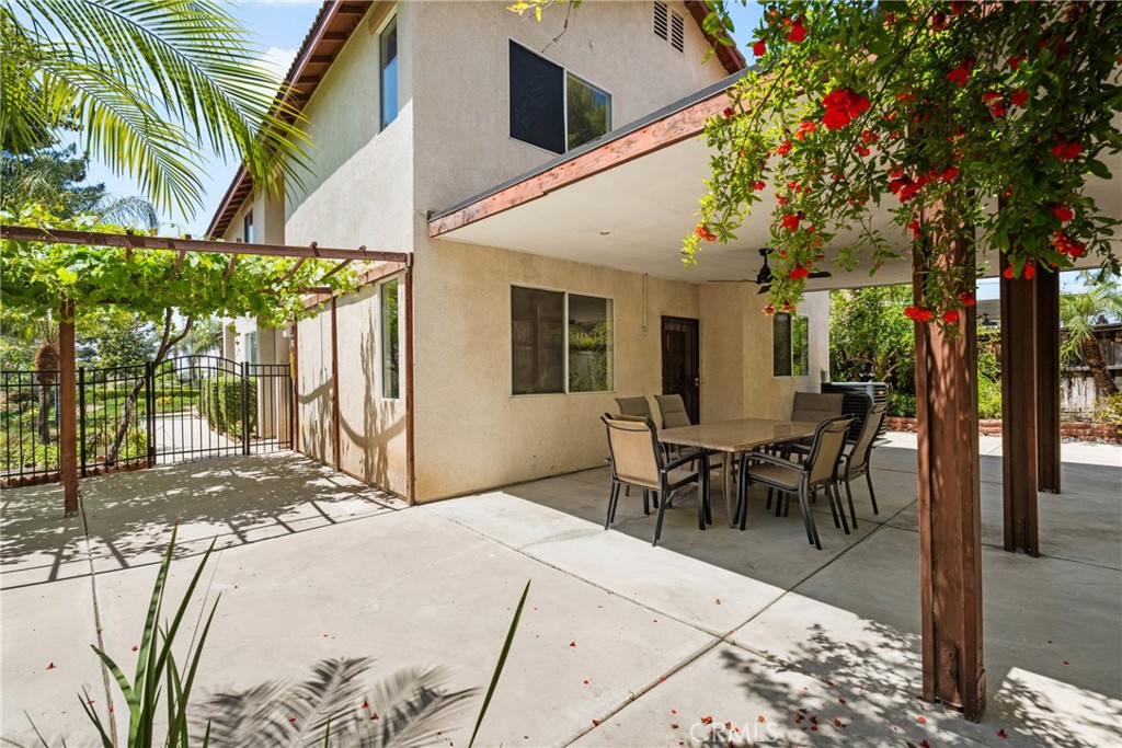 16200 Setting Sun Circle Riverside, CA 92503 - Photo 28 of 41 a view of a patio with table and chairs and potted plants