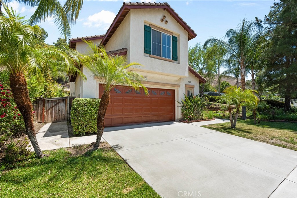 16200 Setting Sun Circle Riverside, CA 92503 - Photo 3 of 41 a front view of a house with a yard garage and outdoor seating