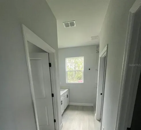 a view of an empty room with a window