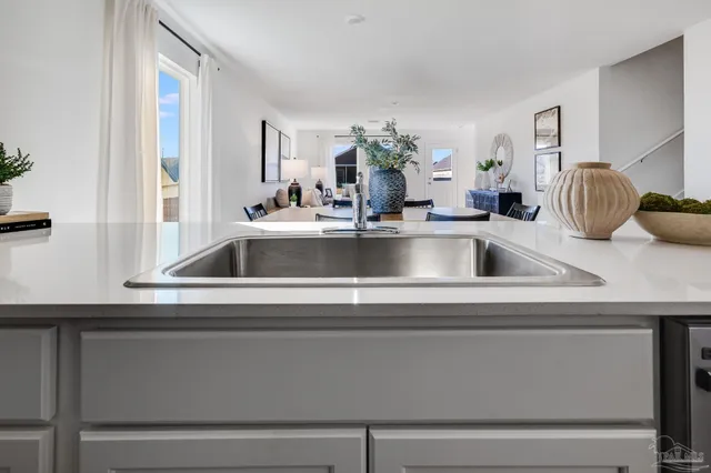 a kitchen with stainless steel appliances white cabinets and a sink