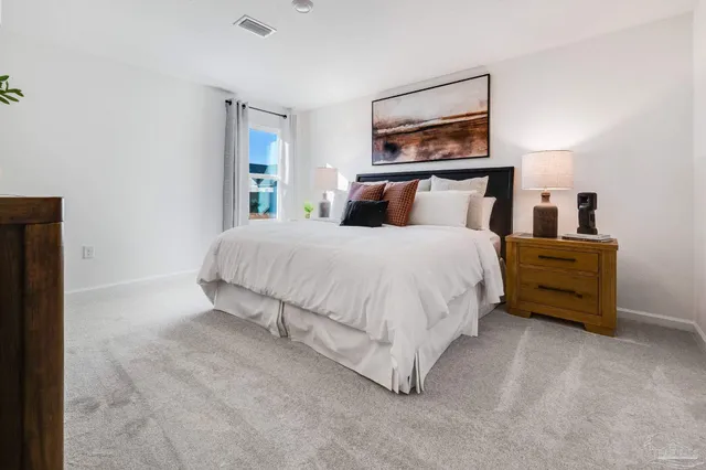 a bedroom with a bed and a night stand