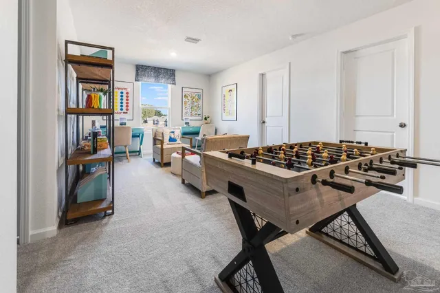 a living room with furniture a rug and a window