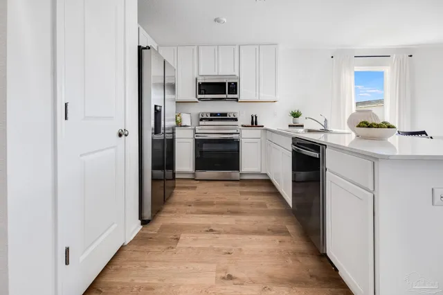 a kitchen with granite countertop a stove top oven and sink