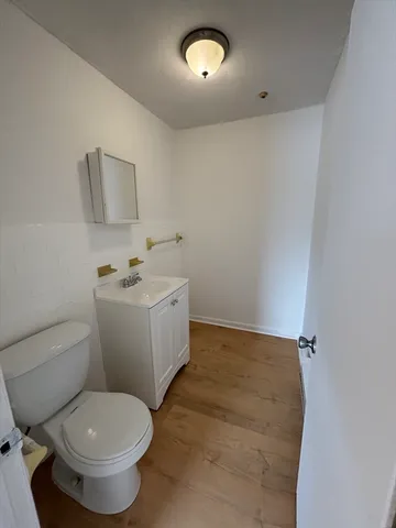 a bathroom with a sink toilet and mirror