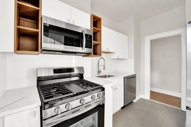 a kitchen with stainless steel appliances and cabinets
