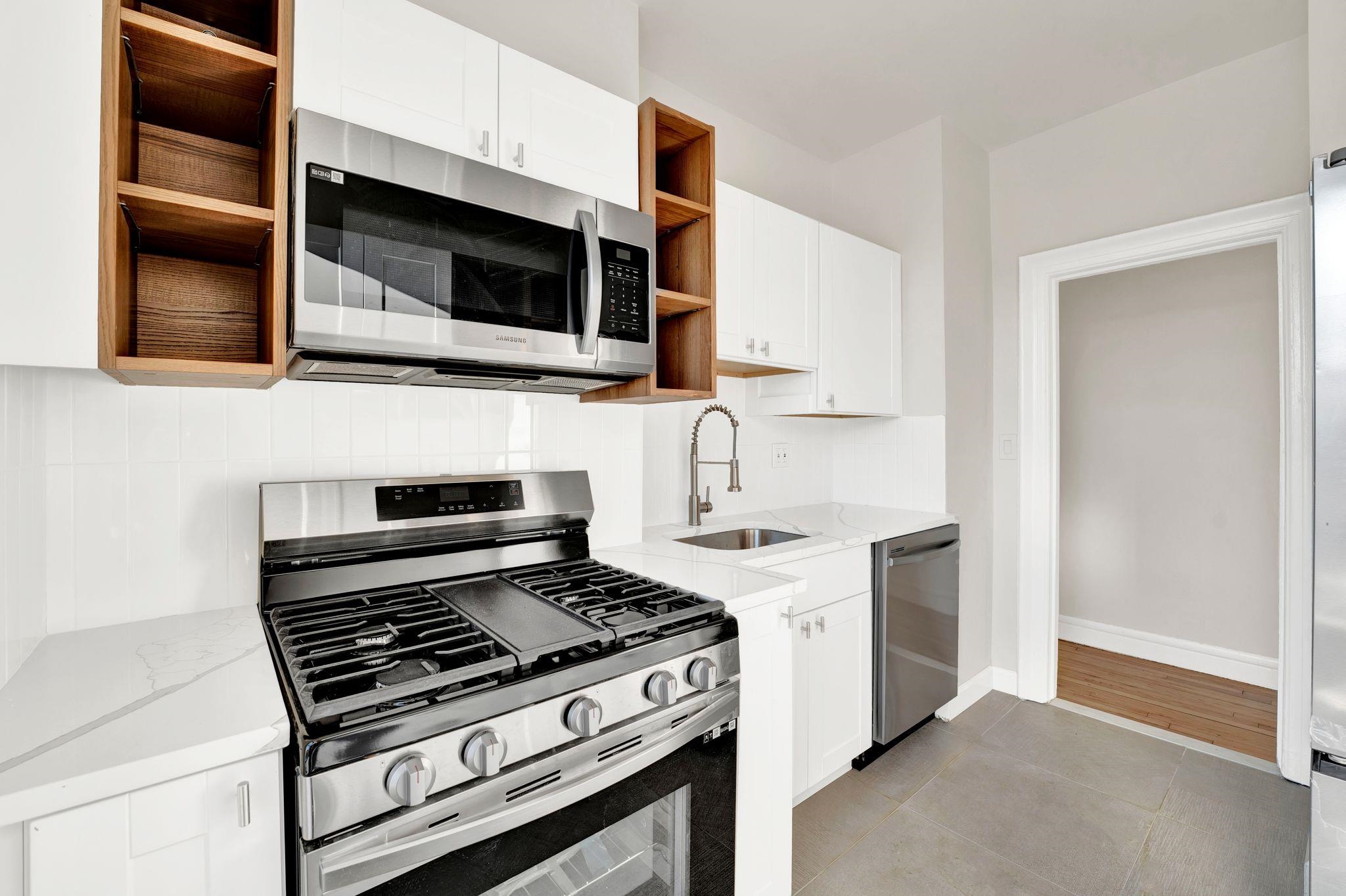 a kitchen with stainless steel appliances and cabinets
