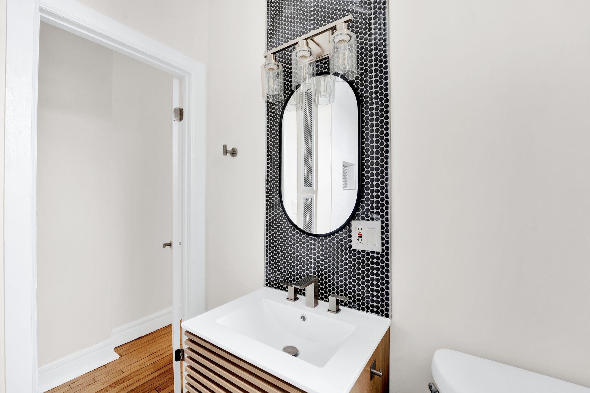 275 Harrison Avenue, Unit E5 Jersey City, NJ 07304 - Photo 15 of 17 a bathroom with a sink and a mirror
