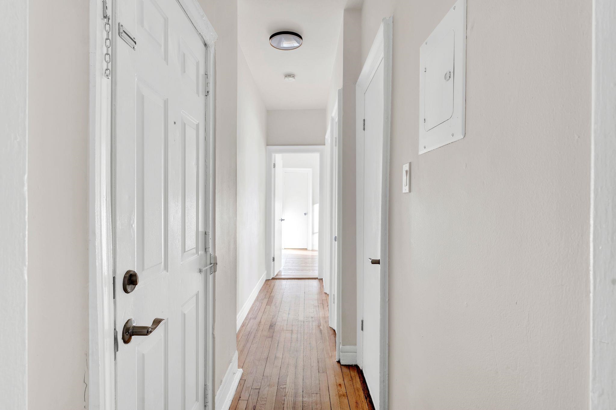 275 Harrison Avenue, Unit E5 Jersey City, NJ 07304 - Photo 5 of 17 a view of a hallway with wooden floor