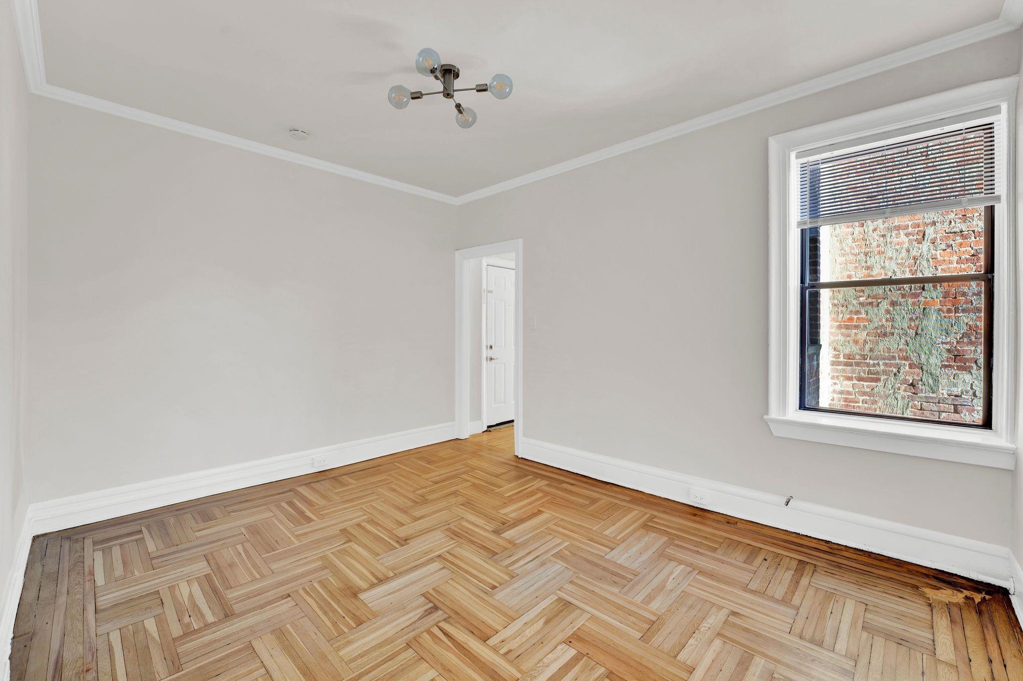 275 Harrison Avenue, Unit E5 Jersey City, NJ 07304 - Photo 6 of 17 a view of an empty room with a window