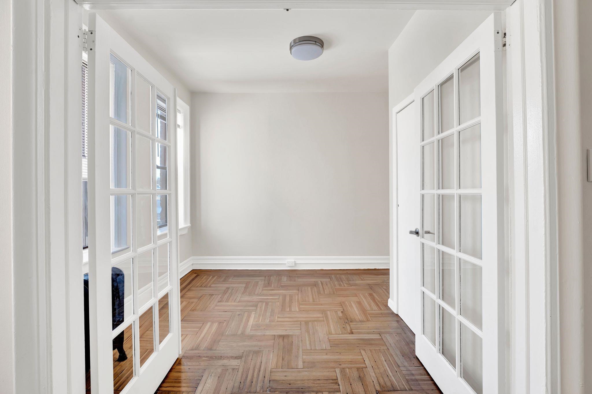 275 Harrison Avenue, Unit E5 Jersey City, NJ 07304 - Photo 8 of 17 a view of a hallway with wooden floor and entryway