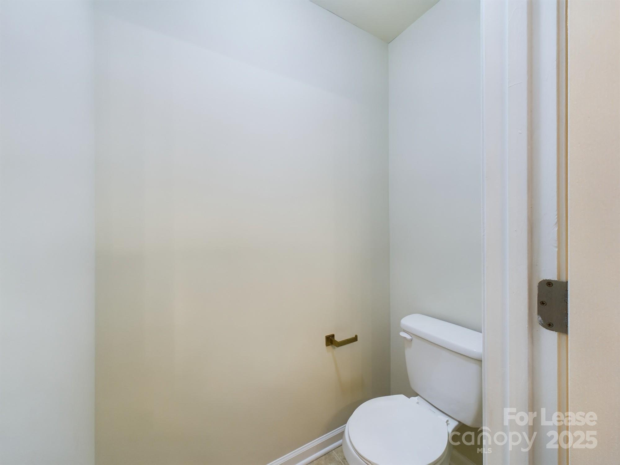13564 Calloway Glen Drive Charlotte, NC 28273 - Photo 14 of 15 a white toilet sitting next to a white wall