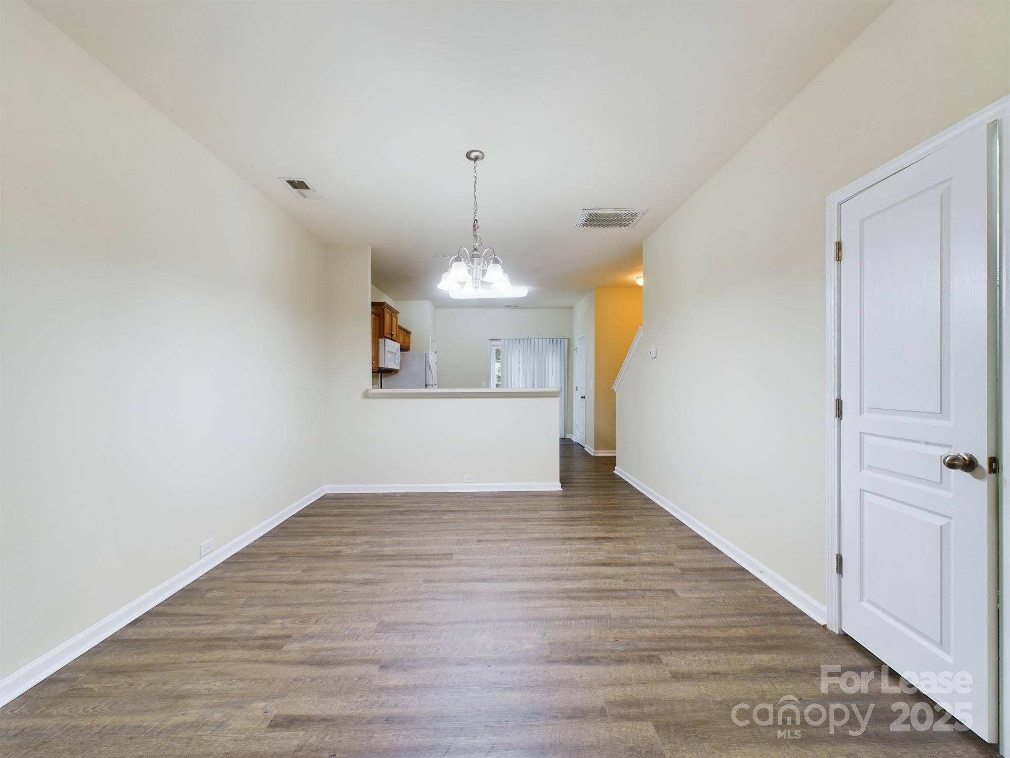 13564 Calloway Glen Drive Charlotte, NC 28273 - Photo 6 of 15 wooden floor in an empty room with a window