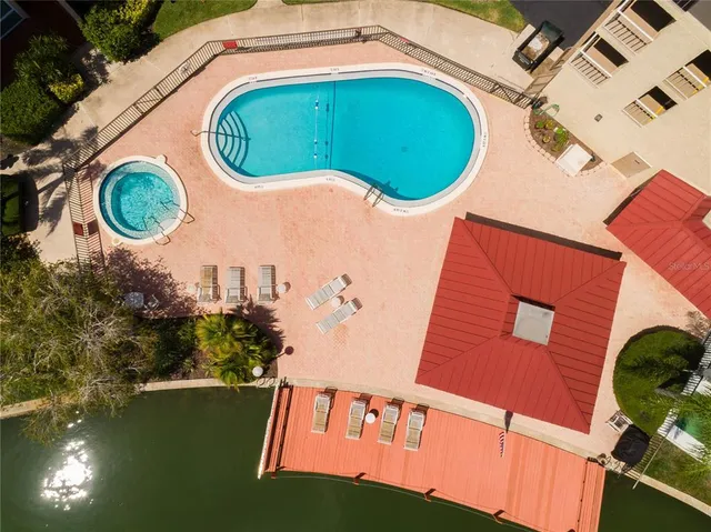 an aerial view of a house with swimming pool and outdoor space