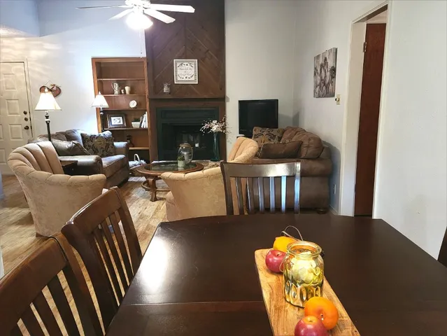 a living room with furniture fireplace and a table