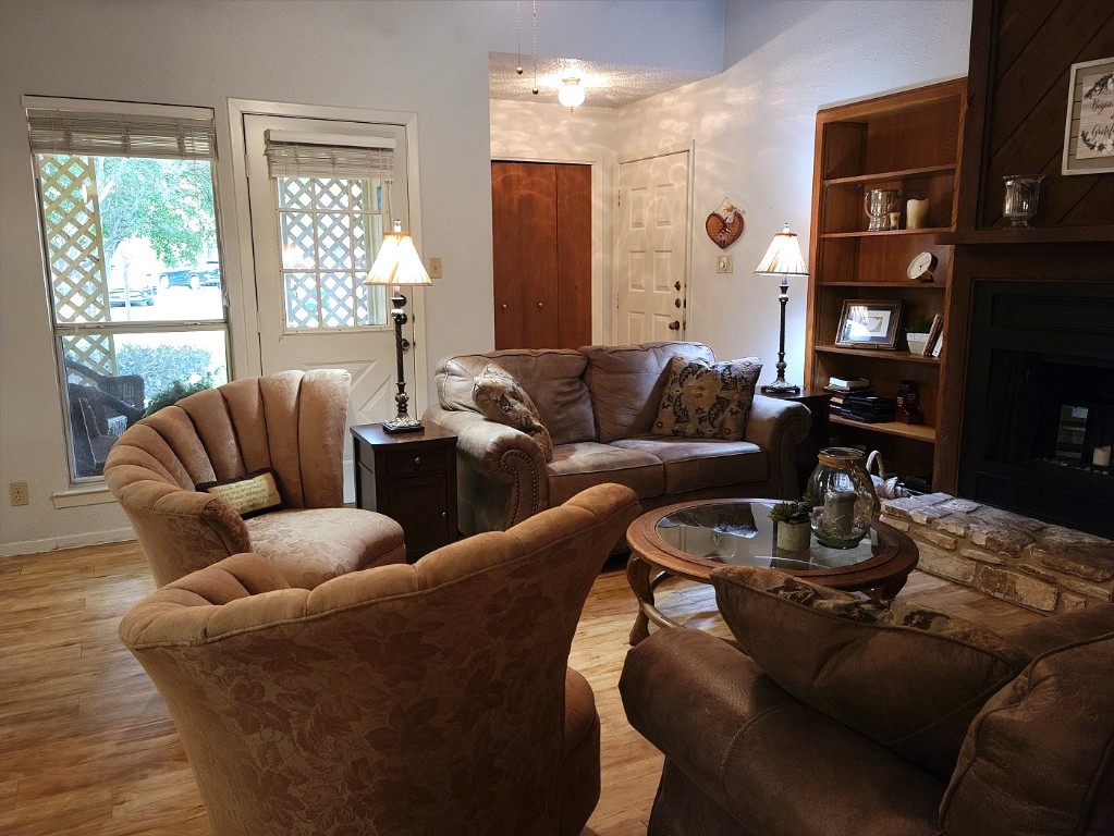 6904 Argonne Forest Cove, Unit A Austin, TX 78759 - Photo 13 of 25 a living room with furniture fireplace and a large window