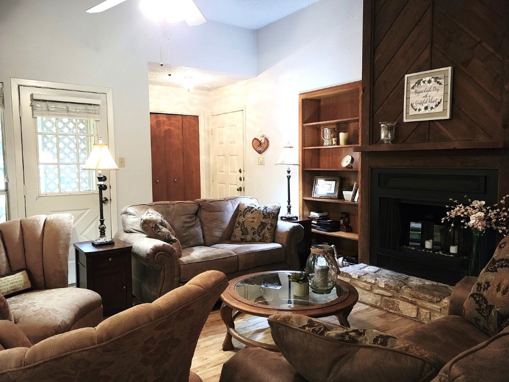 6904 Argonne Forest Cove, Unit A Austin, TX 78759 - Photo 14 of 25 a living room with furniture a fireplace and a large window