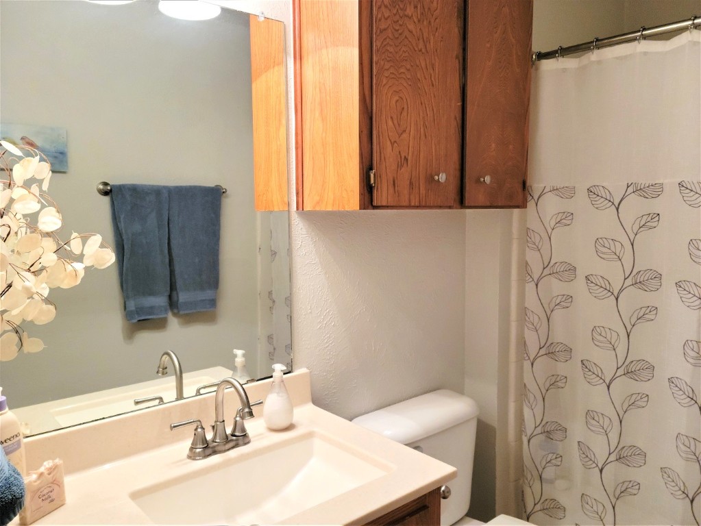 6904 Argonne Forest Cove, Unit A Austin, TX 78759 - Photo 15 of 25 a bathroom with a sink and a mirror
