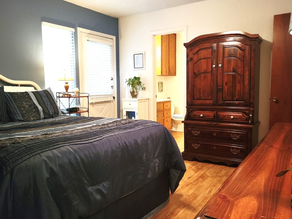 6904 Argonne Forest Cove, Unit A Austin, TX 78759 - Photo 16 of 25 a bedroom with a bed and a window