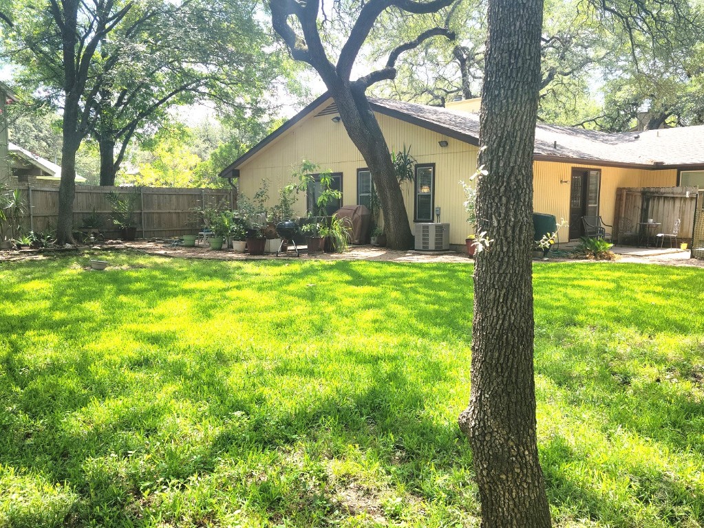 6904 Argonne Forest Cove, Unit A Austin, TX 78759 - Photo 21 of 25 a view of a house with a yard