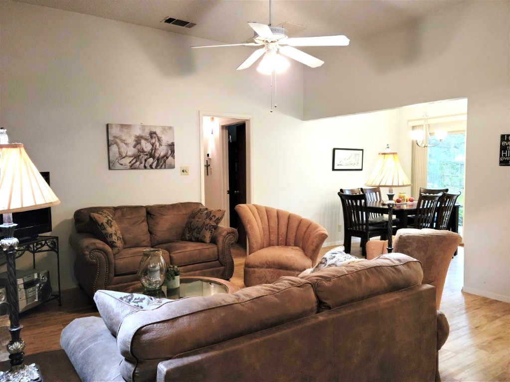6904 Argonne Forest Cove, Unit A Austin, TX 78759 - Photo 3 of 25 a living room with furniture a ceiling fan and a rug