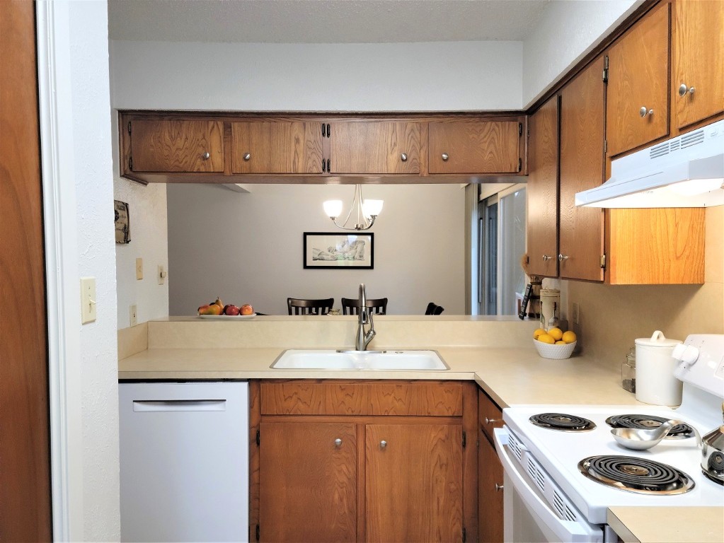 6904 Argonne Forest Cove, Unit A Austin, TX 78759 - Photo 5 of 25 a kitchen with stainless steel appliances granite countertop a sink refrigerator and cabinets