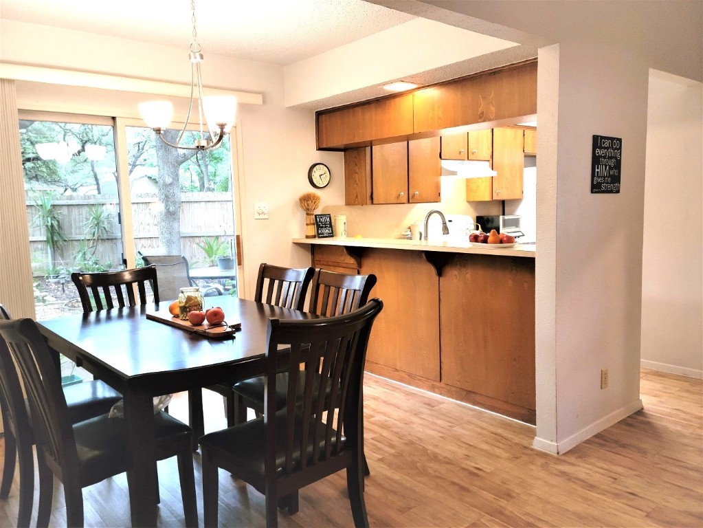 6904 Argonne Forest Cove, Unit A Austin, TX 78759 - Photo 8 of 25 a dining room with furniture and wooden floor
