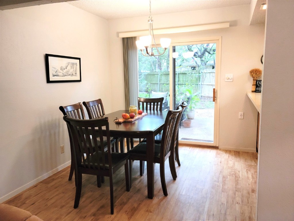 6904 Argonne Forest Cove, Unit A Austin, TX 78759 - Photo 10 of 25 a view of a dining room with furniture window and wooden floor