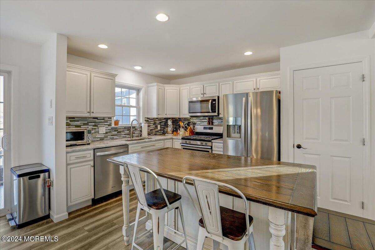 45 Vanard Drive Brick, NJ 08723 - Photo 12 of 52 a kitchen with stainless steel appliances granite countertop a sink a stove a refrigerator cabinets and a counter top space
