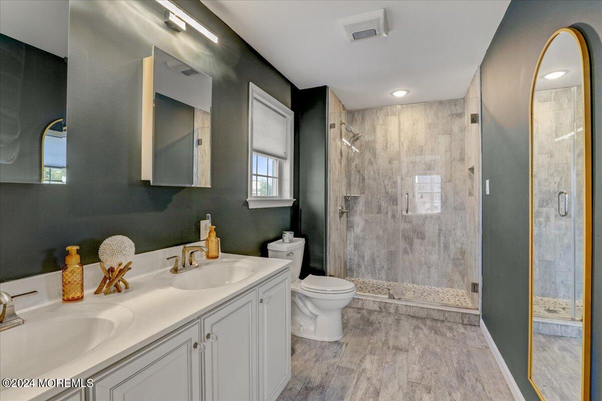 45 Vanard Drive Brick, NJ 08723 - Photo 19 of 52 a bathroom with a sink a toilet and shower