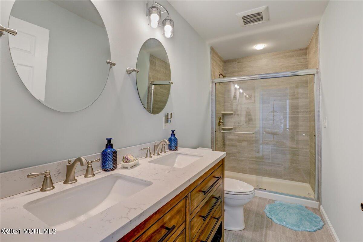 45 Vanard Drive Brick, NJ 08723 - Photo 27 of 52 a bathroom with a sink a toilet and a mirror