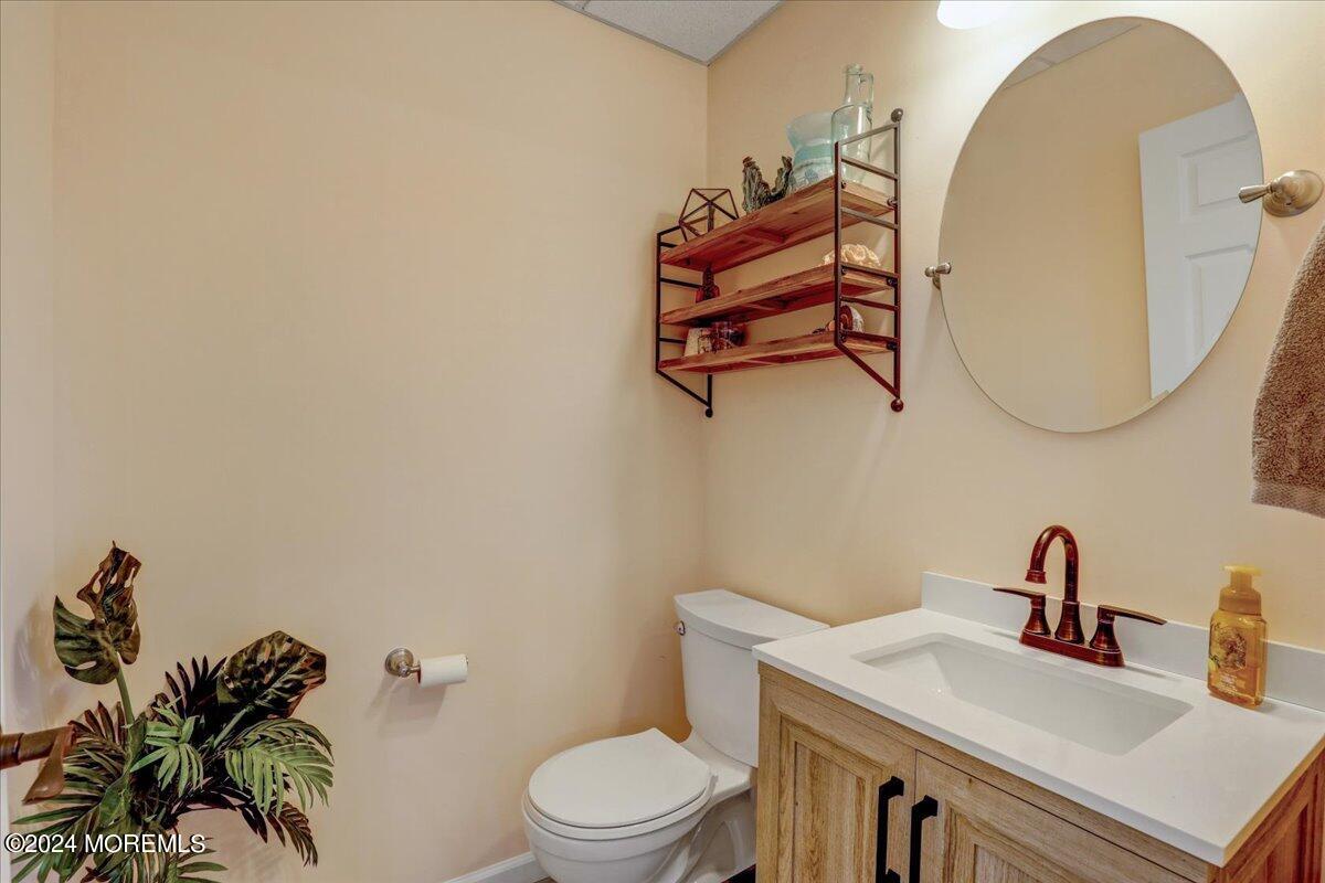 45 Vanard Drive Brick, NJ 08723 - Photo 33 of 52 a bathroom with a toilet sink and mirror