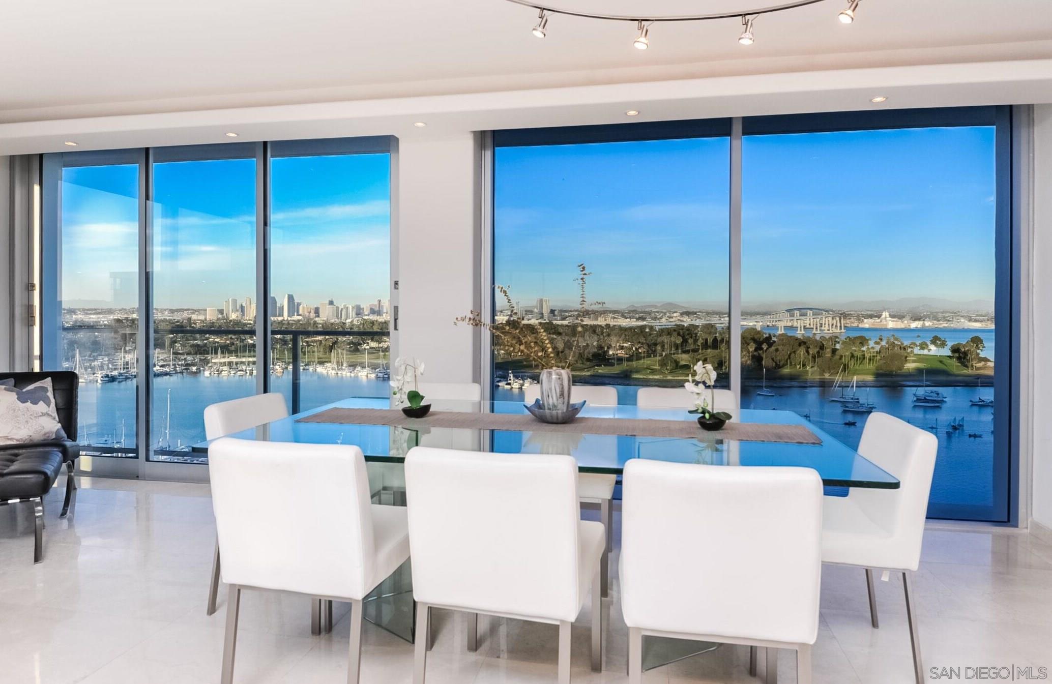 a dining room with furniture water view and city view