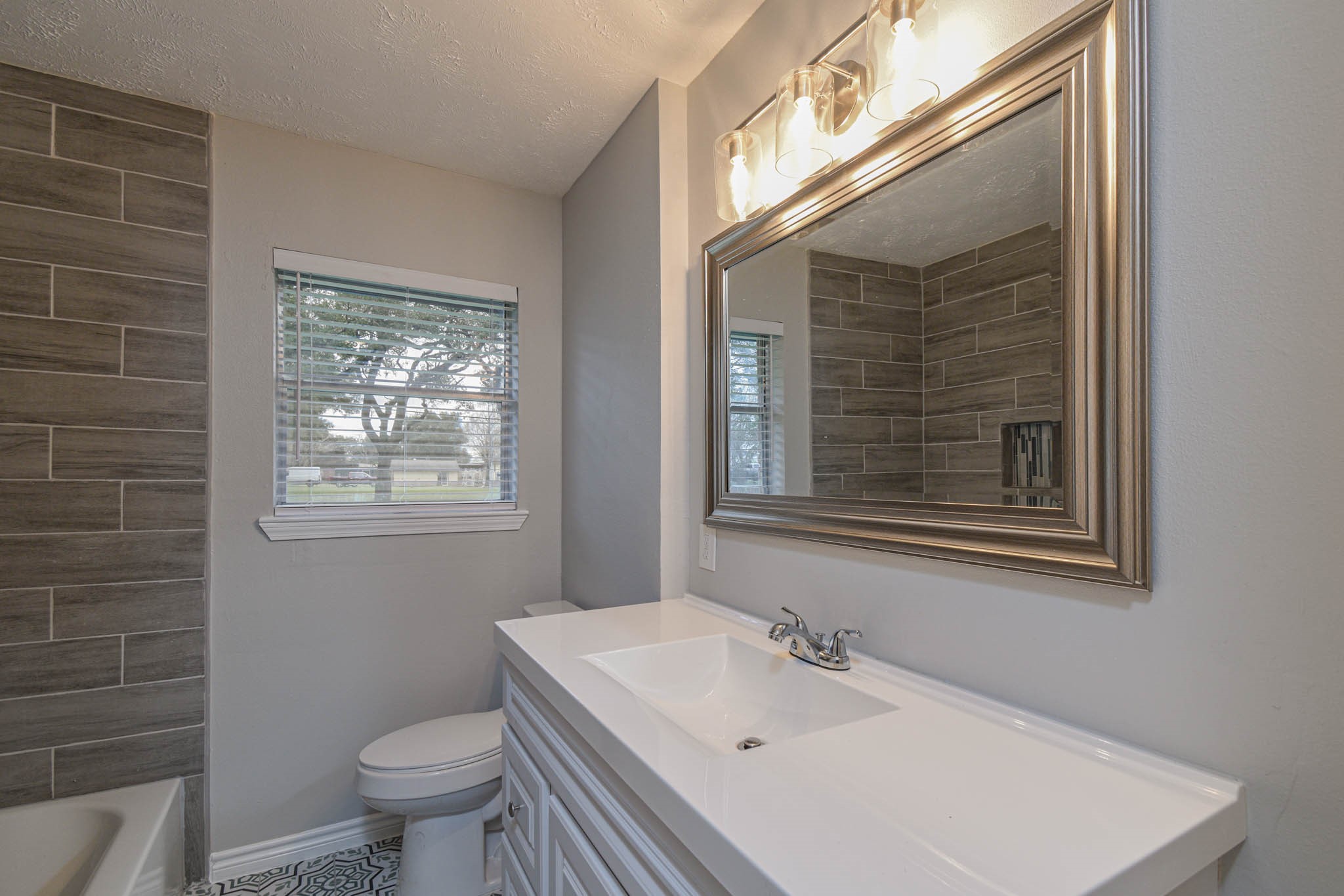 2834 Pansy Street Pasadena, TX 77503 - Photo 23 of 33 Completely Remodeled Hall Bath - Updated & has Never Been Used! Recent Tile Flooring, Vanity Cabinet, Tub & Tile Surround, Toilet, Lighting Fixtures and Faucets!