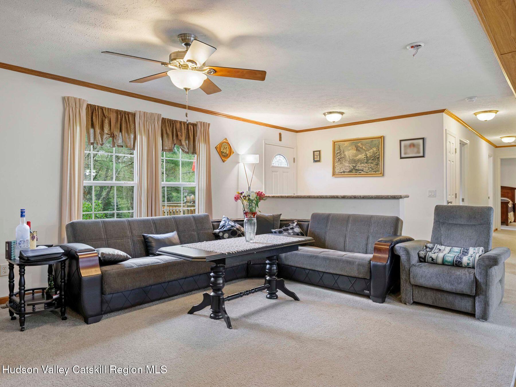 137 Mountain Pond View Road Gilboa, NY 12076 - Photo 18 of 38 a living room with furniture and a large window