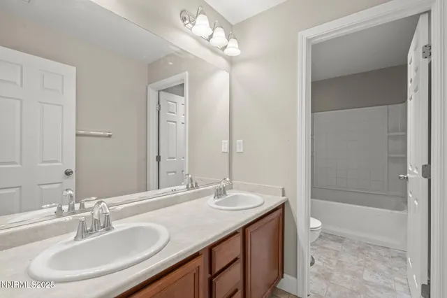 a bathroom with a sink double vanity and a mirror