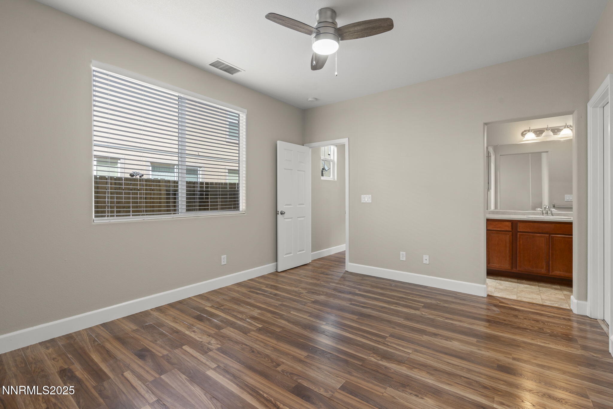 1955 Echo Valley Parkway Reno, NV 89521 - Photo 9 of 26 a view of an empty room with a window and wooden floor