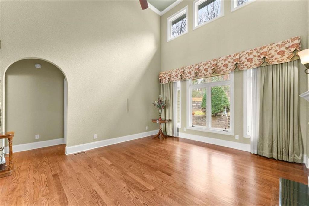 777 Oak Pointe Drive Cleveland, GA 30528 - Photo 13 of 63 an empty room with wooden floor and windows