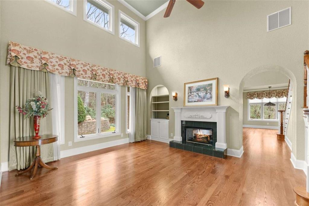 777 Oak Pointe Drive Cleveland, GA 30528 - Photo 14 of 63 a view of an empty room with wooden floor fireplace and a window