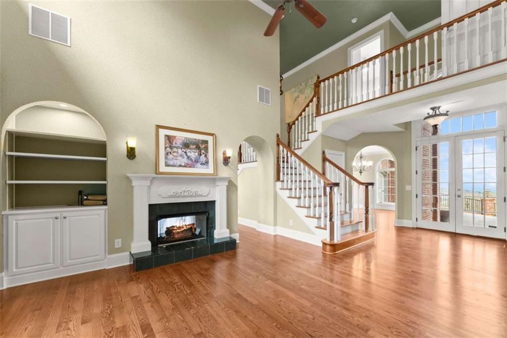 777 Oak Pointe Drive Cleveland, GA 30528 - Photo 15 of 63 a view of an empty room with wooden floor fireplace and a window