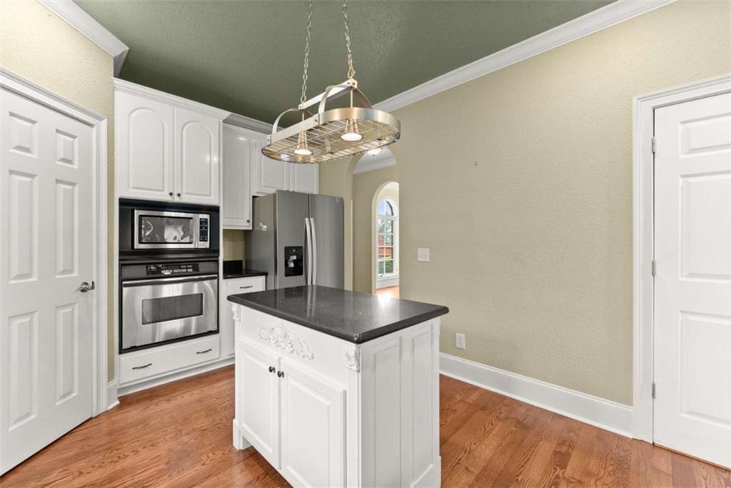 777 Oak Pointe Drive Cleveland, GA 30528 - Photo 17 of 63 a kitchen with stainless steel appliances granite countertop a refrigerator a oven a stove and a sink with wooden floor