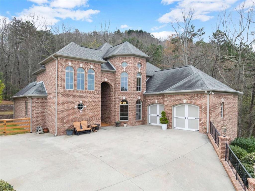 777 Oak Pointe Drive Cleveland, GA 30528 - Photo 2 of 63 a front view of a house with a yard and garage