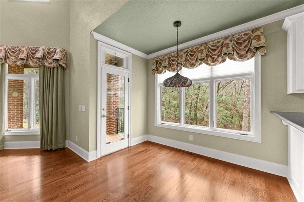 777 Oak Pointe Drive Cleveland, GA 30528 - Photo 22 of 63 a view of an empty room with a window and wooden floor